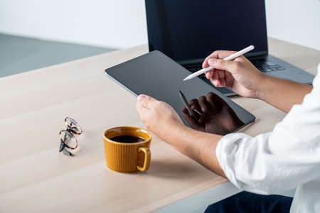 Man using stylus pen for digital tablet.の写真素材
