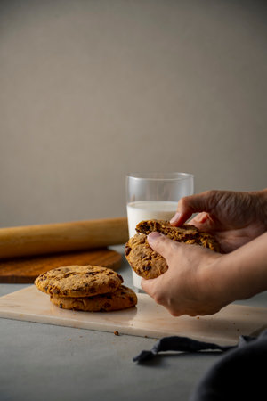 Dip a chocolate chip cookie in milk.
Sweet chocolate chip cookie picture.の写真素材