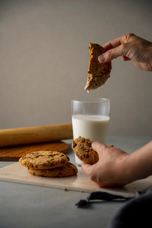 Dip a chocolate chip cookie in milk.
Sweet chocolate chip cookie picture.の写真素材