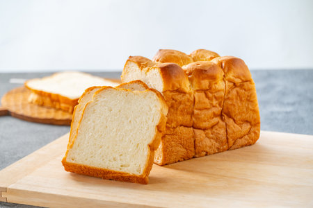 Sliced white bread on wooden board. Delicious white bread image.