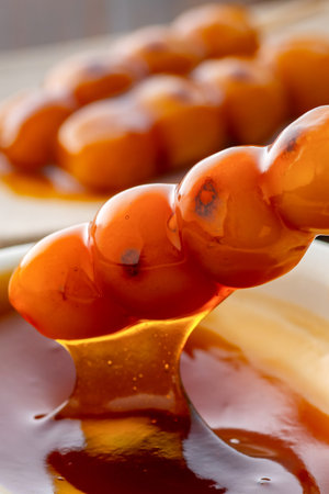 Grilled Mitarashi Dango with Sweet Soy Glaze.A close-up of traditional Japanese mitarashi...