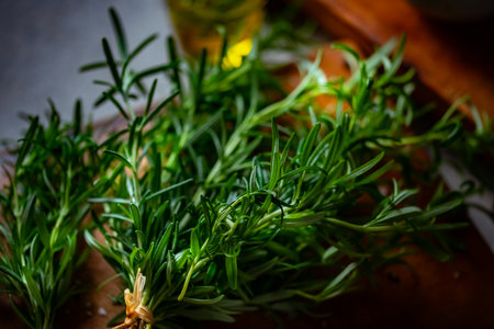 Rosemary, Salt, and Olive Oil. Fresh rosemary, rock salt, and olive oil on a cutting board, perfect for culinary themes.の写真素材