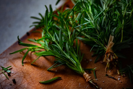 Rosemary, Salt, and Olive Oil. Fresh rosemary, rock salt, and olive oil on a cutting board, perfect for culinary themes.の写真素材