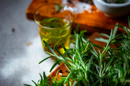 Rosemary, Salt, and Olive Oil. Fresh rosemary, rock salt, and olive oil on a cutting board, perfect for culinary themes.の写真素材