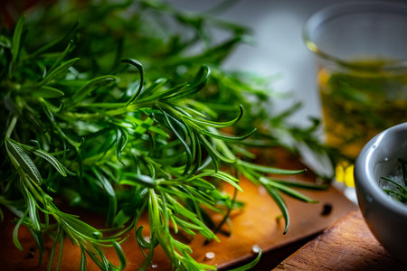 Rosemary, Salt, and Olive Oil. Fresh rosemary, rock salt, and olive oil on a cutting board, perfect for culinary themes.の写真素材