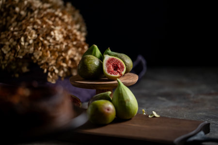 Fresh Figs Still Life.A moody still life photograph of fresh, ripe figs. The dramatic lighting...