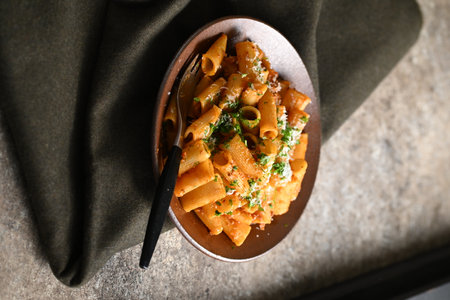 Rigatoni Pasta Dish A close-up photo of a rigatoni pasta dish served on a plate. Perfect for food, restaurant, or culinary-themed projects.の写真素材