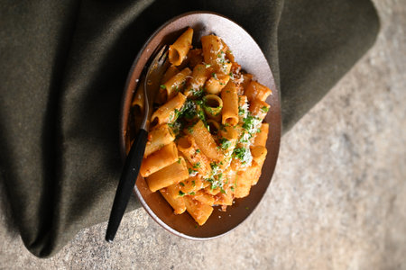 Rigatoni Pasta Dish A close-up photo of a rigatoni pasta dish served on a plate. Perfect for food, restaurant, or culinary-themed projects.の写真素材