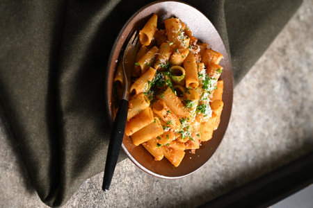 Rigatoni Pasta Dish A close-up photo of a rigatoni pasta dish served on a plate. Perfect for food, restaurant, or culinary-themed projects.の写真素材