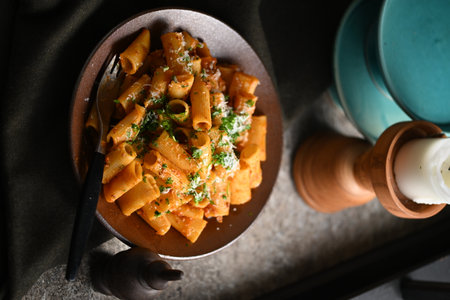 Rigatoni Pasta Dish A close-up photo of a rigatoni pasta dish served on a plate. Perfect for food, restaurant, or culinary-themed projects.の写真素材