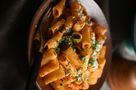 Rigatoni Pasta Dish A close-up photo of a rigatoni pasta dish served on a plate. Perfect for food, restaurant, or culinary-themed projects.の写真素材