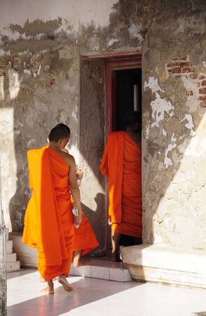 SAMUT SAKHON, THAILAND - JAN 21, 2009 Clergy is walking into church to pray. It is the church of Khok Kham temple, Samut Sakhon, Thailand.のeditorial素材