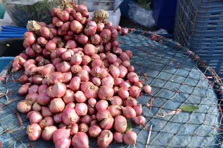 Shallot on a basket Sold in a rural market in Thailand.の写真素材