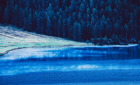 a foggy lake in the early morningの写真素材