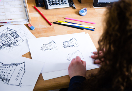 Graphic designer drawing with pencil in the officeの写真素材