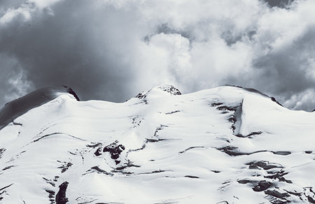 enormous Alpine mountain landscape with snow and clouds