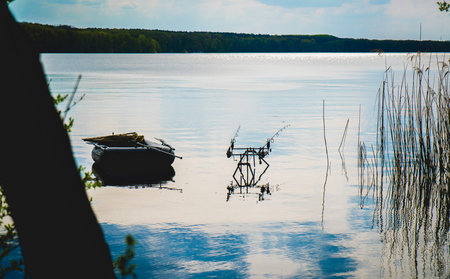 abandoned canoe on a beautiful lake at sunの写真素材