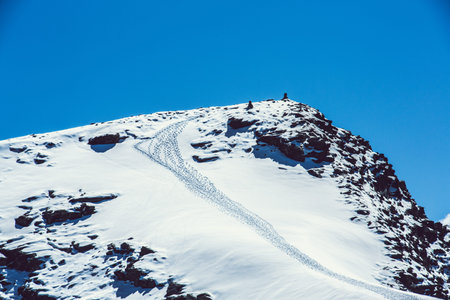 mountain peak with tracks in the snow