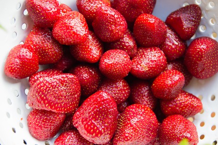 many fresh red strawberries in a bowlの写真素材