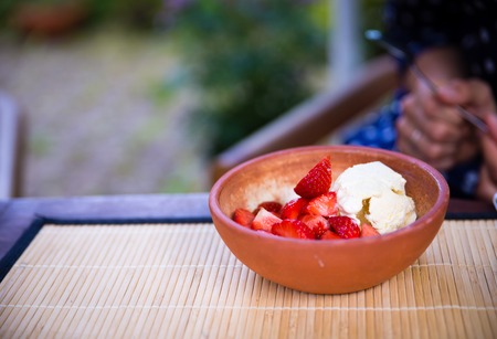 Vanilla ice cream with wild strawberry at summer selective focusの写真素材