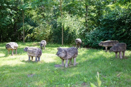 wooden sheep figures on sunny meadow grasslandの写真素材