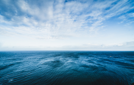 Blue sea surface with waves and beautiful skyの写真素材