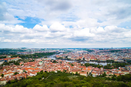 Cityscape of Prague, Czech Republic. View on traditional red roof tenement houses as seen from Old Town City Hall. Blue sunny sky, wide angle skylineの写真素材
