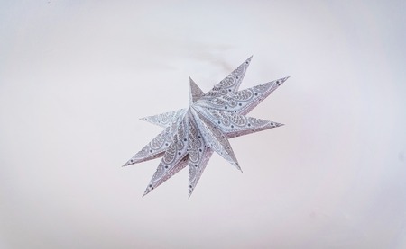 Decorative star made of paper on room ceilingの写真素材