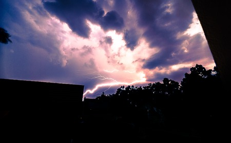 Fork lightning striking down during summer storm.の写真素材