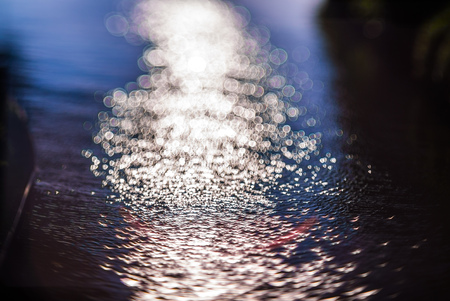 Vintage Water bokeh background with particles of lightの写真素材