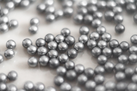 Metallic silver bearing balls on white backgroundの写真素材