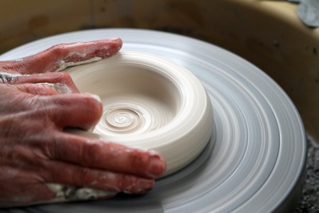 hands of a potter creating ceramic on the circleの写真素材