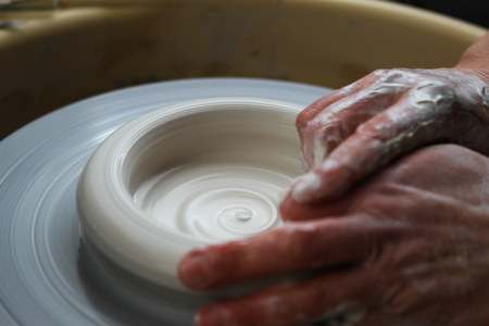 Closeup on hands of potter on potters wheelの写真素材