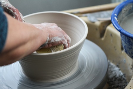 hands of a potter creating ceramic on the circleの写真素材