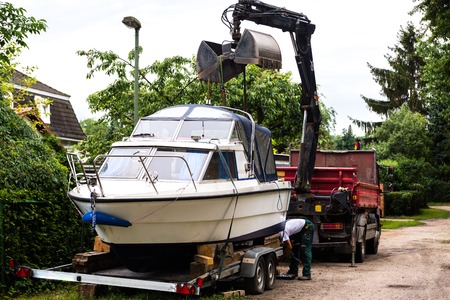 semi boat loading for transport on transporter van truckの写真素材