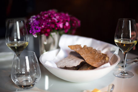 beautiful decoration of dining table with bread and wine glasses