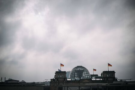 building of the German Bundestag from outside with dark, cloudy skyの写真素材