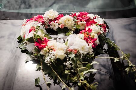 bridal bouquet in heart shape on carの写真素材