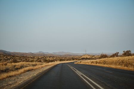 view out of a car on lonely road in Namibiaの写真素材