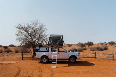 Tent located on the roof of a pickup 4x4 car in a desert campの写真素材