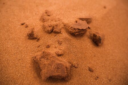 texture of red sand with structures and small stones in African desertの写真素材