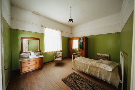Interior of a colonial green sleeping room with bed and furnituresの写真素材