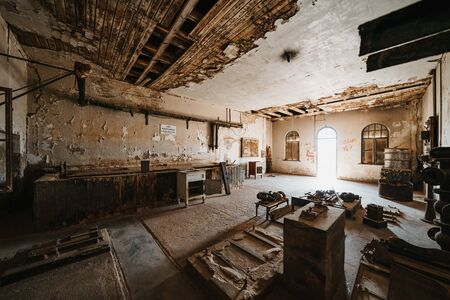 abandoned old workstation in ruined partially collapsed buildingの写真素材