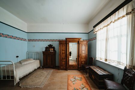 Interior of colonial blue sleeping room with bed and shelvesの写真素材