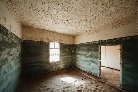 Sand Dune filling up abandoned Ghost Town House through doors and broken windowの写真素材