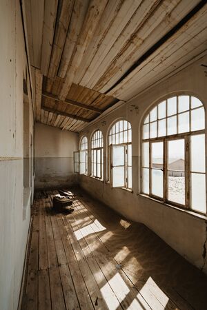 beautiful western villa with big windows and desert sand coverding the floorの写真素材