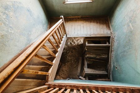 Old staircase in abandoned house filled with sand, Kolmanskop Ghost Townの写真素材