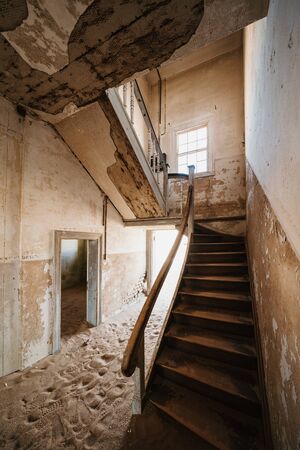 Old staircase in abandoned house filled with sand, Kolmanskop Ghost Town, Namibiaの写真素材