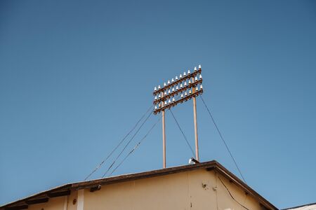 Roof top of old building with historic power polesの写真素材