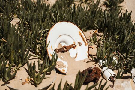 concept photo of decay and time - rotten equipment in desert sandの写真素材